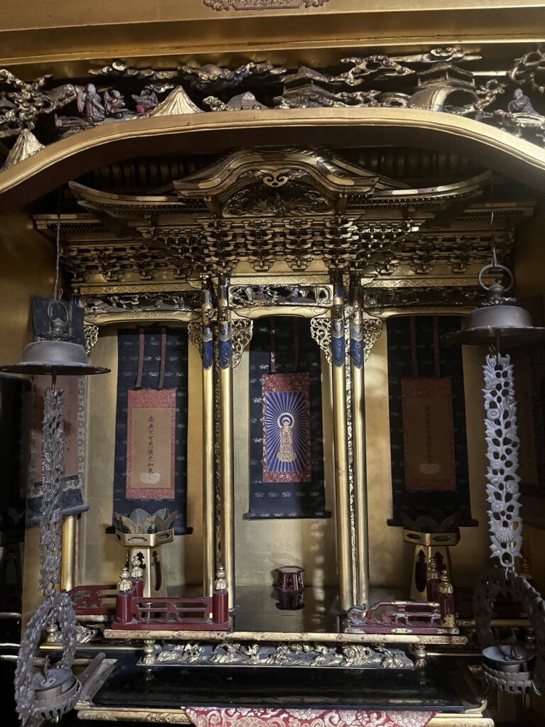 仏壇内部には仏具や吊るされた装飾品がある
